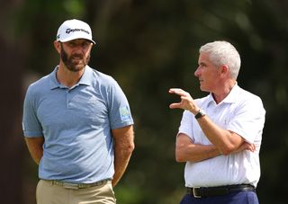 Monahan converses with Dustin Johnson on the seventh tee during a pro-am prior to the RBC Heritage at Harbor Town Golf Links
