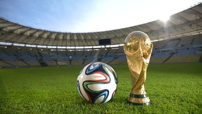 The new Brazuca ball and the FIFA World Cup Trophy