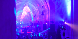 A large party with club lights inside Versialles.