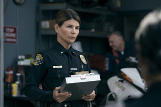 Lori Loughlin as Lieutenant Bishop, wearing a police officer uniform and carrying a clipboard, in 'On Call.'