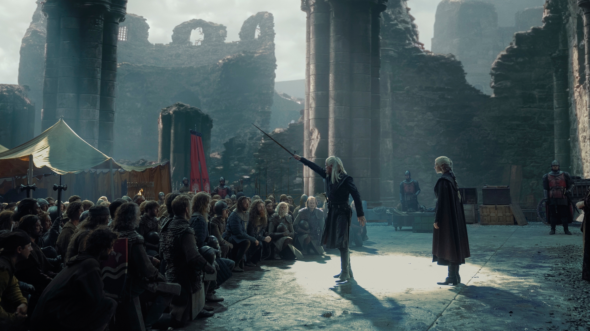 Daemon (Matt Smith) and Rhaenyra (Emm D'Arcy) in front of a kneeling crowd in 
