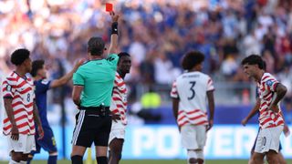 Referee Raphael Claus showing USA's Folarin Balogun a red card at World Cup 2026