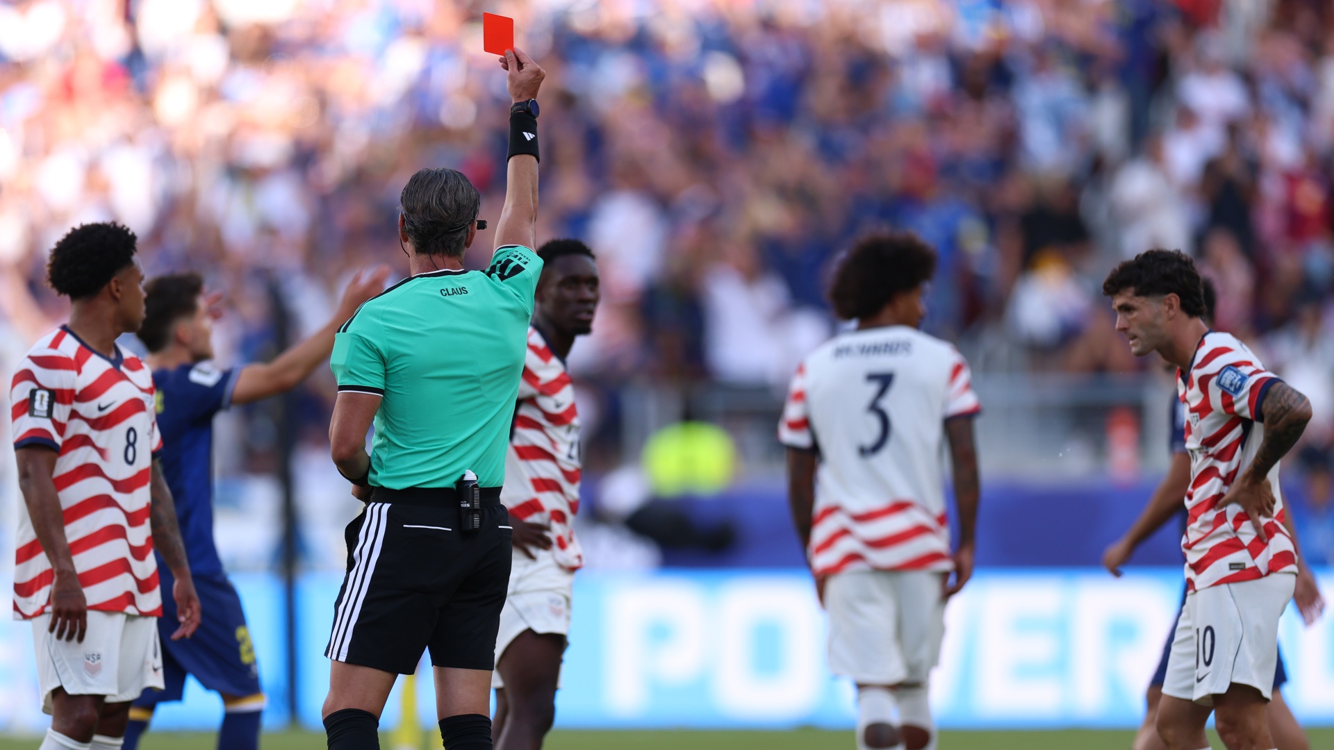 Referee Raphael Claus showing USA's Folarin Balogun a red card at World Cup 2026
