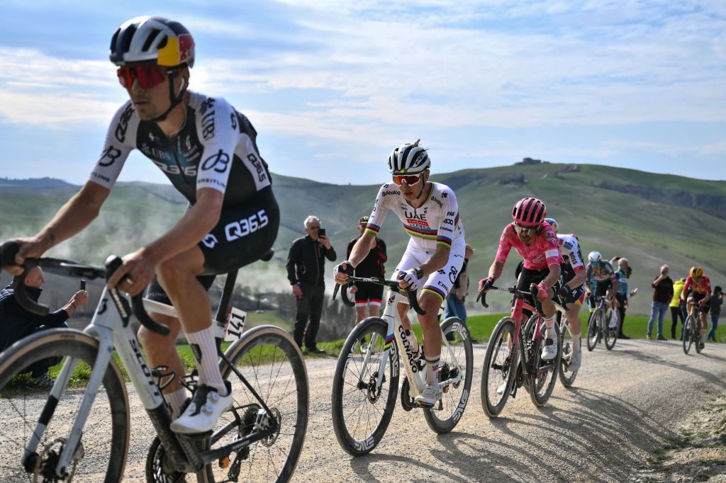 (From L) Team Q36.5's Thomas Pidcock, Team UAE's slovenain rider Tadej Pogacar and Team EF Education's Dutch rider Ben Healy lead the race during the 19th one-day classic Strade Bianche (White Roads) men's cycling race between Siena and Siena in Tuscany on March 8, 2025. (Photo by Marco BERTORELLO / AFP)