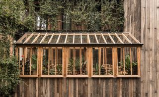 A greenhouse on the veranda houses medicinal plants