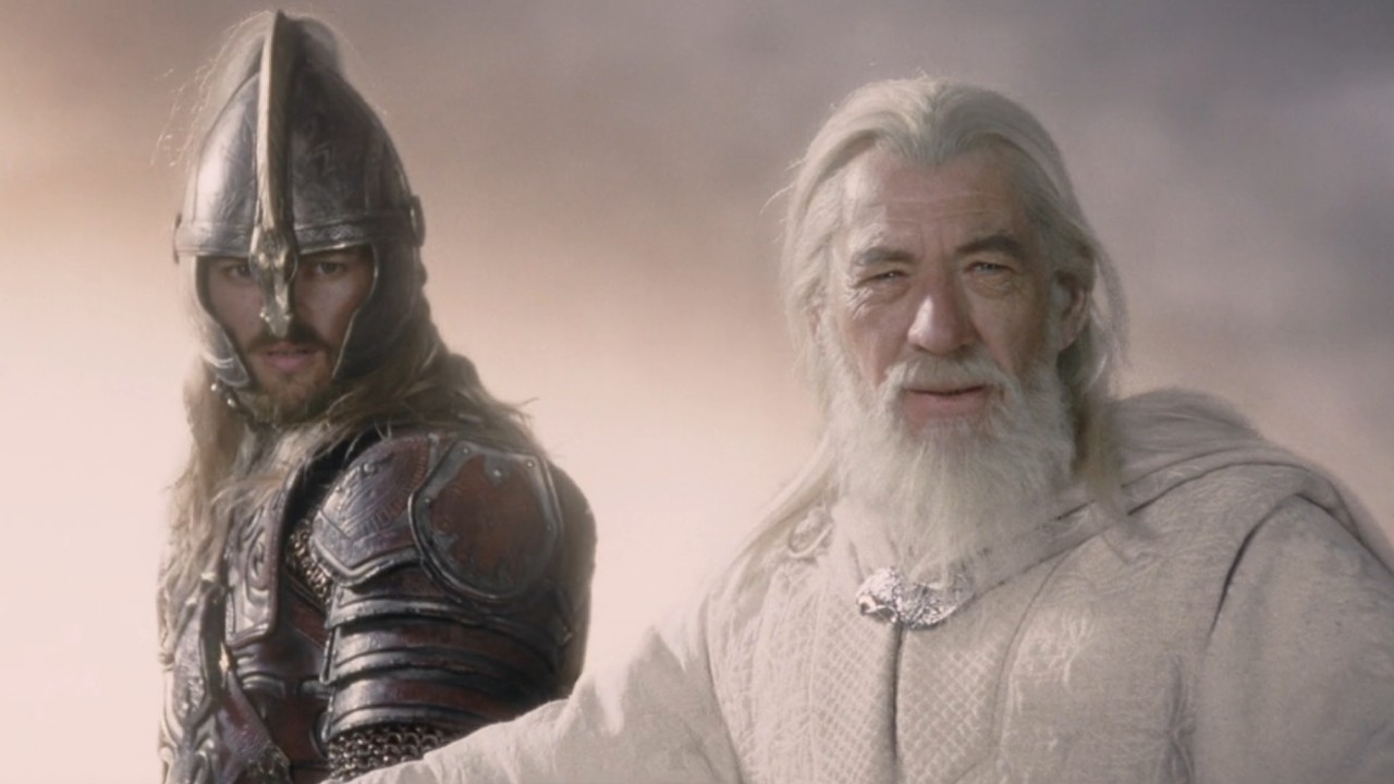 Éomer and Gandalf looking down at a battle that they've just arrived at.