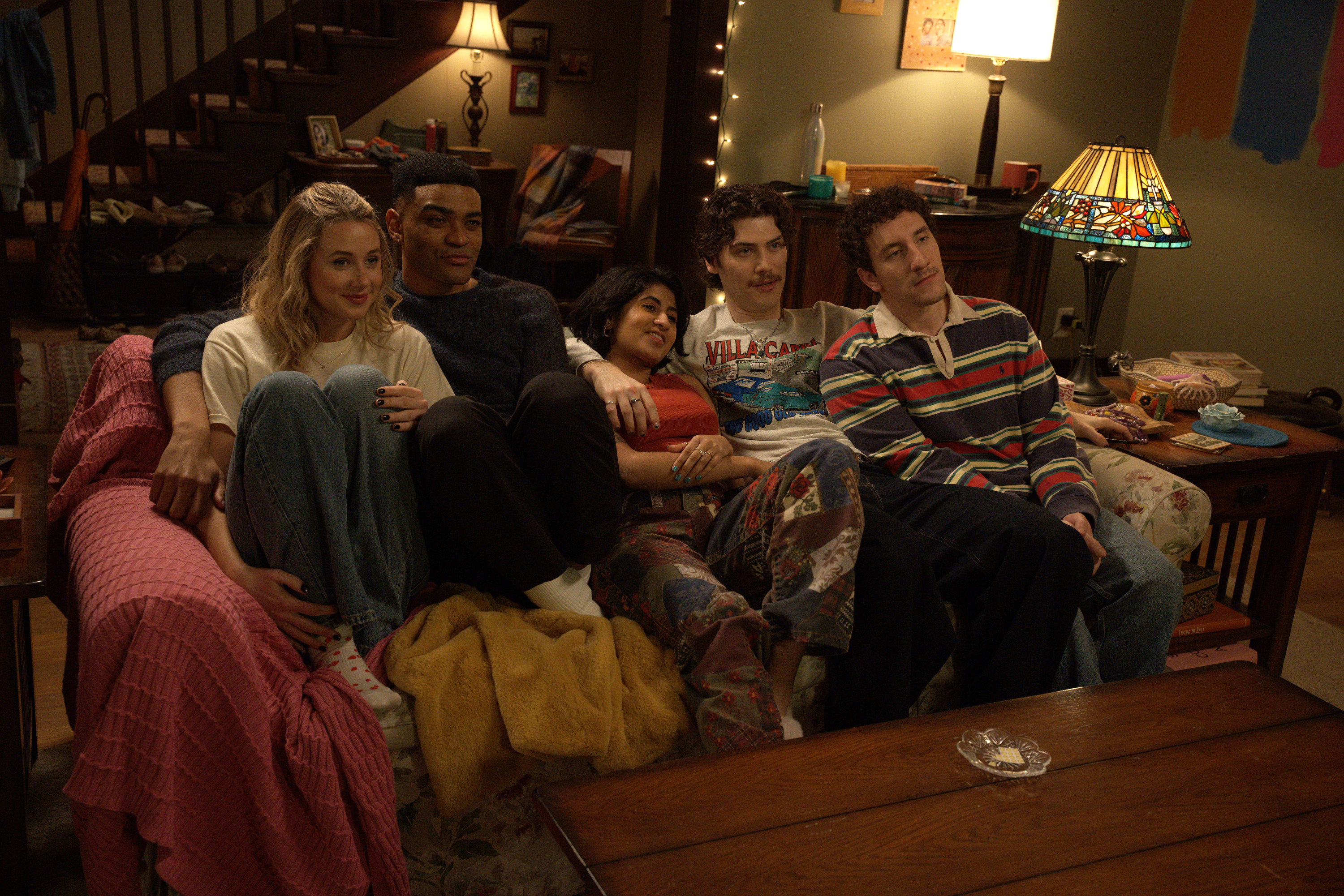 Lucy Freyer as Billie, Owen Thiele as Anton, Amita Rao as Issa, Jack Innanen as Paul Baker, Malik Elassal as Samir cuddle together on a living room couch in the FX series 'Adults.'