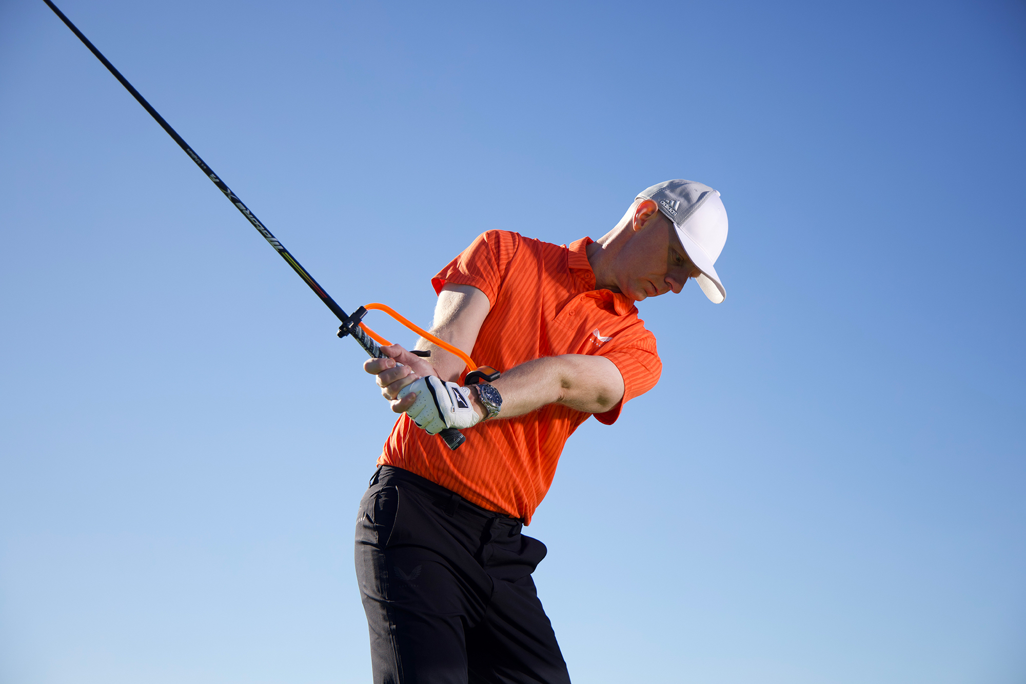 Ged Walters using a training aid to perfect his wrist set in the backswing with driver