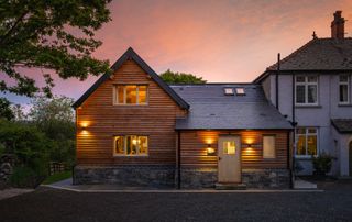 exterior shot of large oak frame extension attached to side of period property