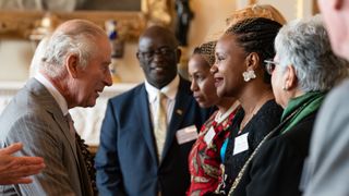King Charles with Ms Roseline Njogu during a reception