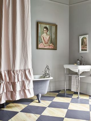 bathroom with freestanding bath and basin and painted floor