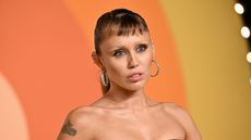 miley cyrus on an orange background