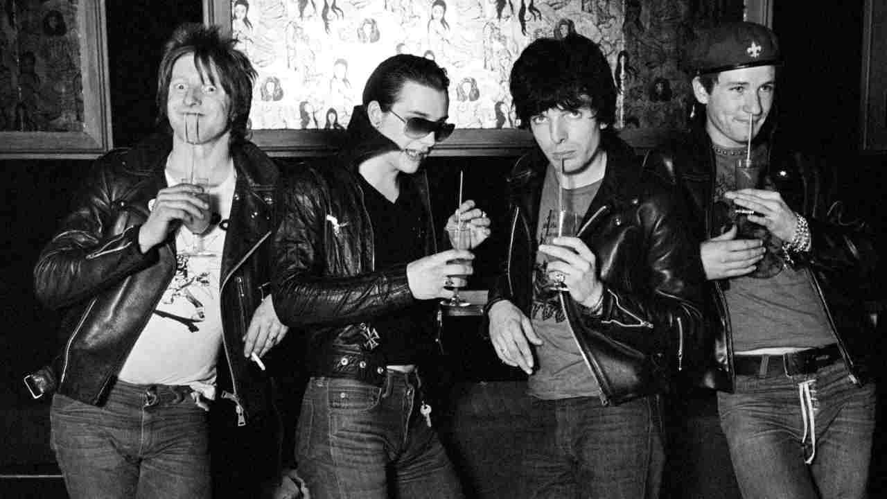 The Damned posing for a photograph in a bar in 1977