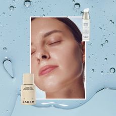 a blue serum background with two beige and white lactic acid bottles next to a woman with super clear, hydrated skin