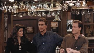 Cheers starring Ted Danson, Kirstie Alley, and Woody Harrelson stood at the bar