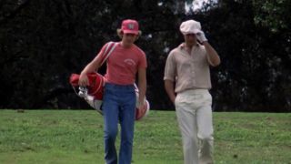 Chevy Chase and another man walk down a fairway in Caddyshack