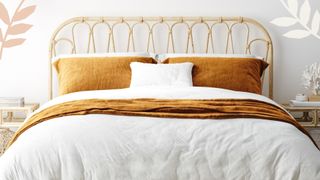 A coastal boho style bed with high thread count bed linen
