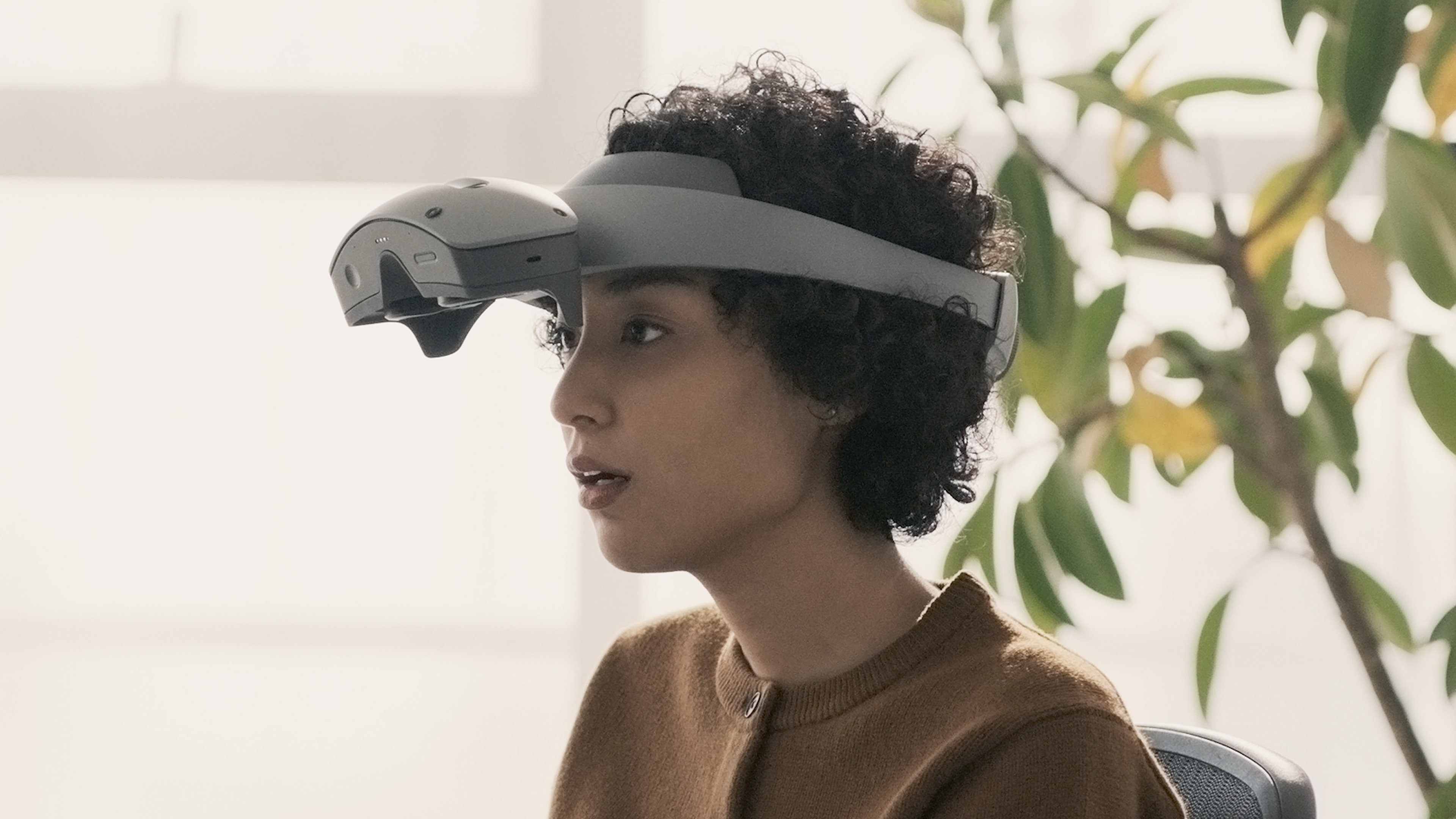 The unnamed Sony XR headset with its display flipped up so the user's eyes are unblocked.