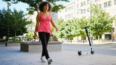 Woman walking in city on sunny day