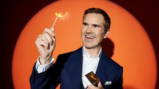 Jimmy Carr holding a match