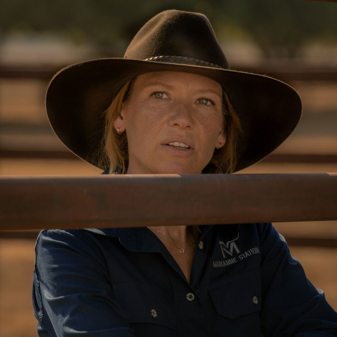 Anna Torv as Emily Lawson, standing behind a wooden fence, in &#039;Territory.&#039;