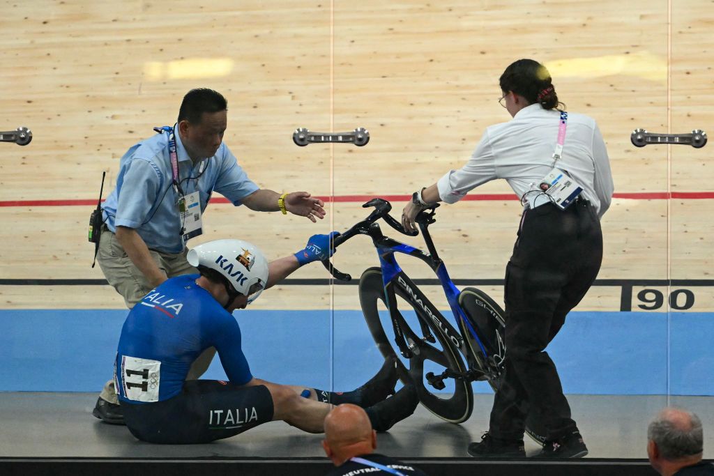 Italy's Simone Consonni suffers a crash in the men's track cycling madison final of the Paris 2024 Olympic Games at the Saint-Quentin-en-Yvelines National Velodrome in Montigny-le-Bretonneux, south-west of Paris, on August 10, 2024. (Photo by SEBASTIEN BOZON / AFP)