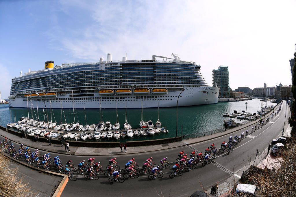 SANREMO ITALY MARCH 19 A general view of the peloton passing through Savona harbour landscape during the 113th MilanoSanremo 2022 a 293km one day race from Milano to Sanremo MilanoSanremo on March 19 2022 in Sanremo Italy Photo by Tim de WaeleGetty Images