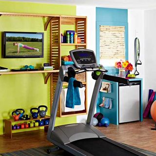 home gym with grey treadmill and wooden floor