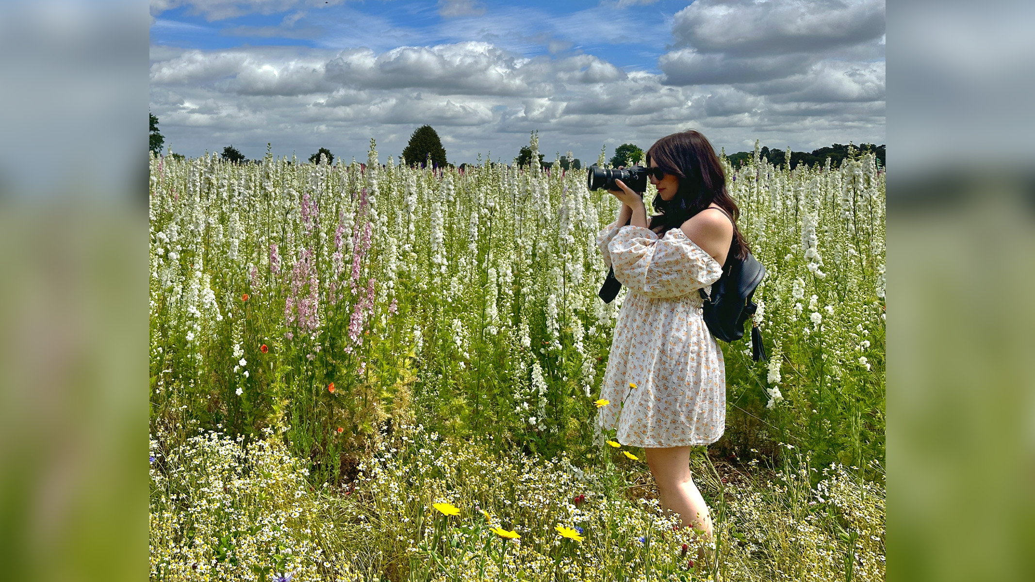 author using the camera in a flower field