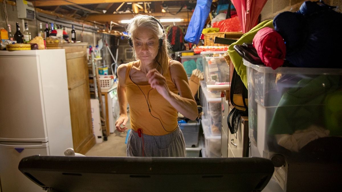 Woman running on treadmill in a garage