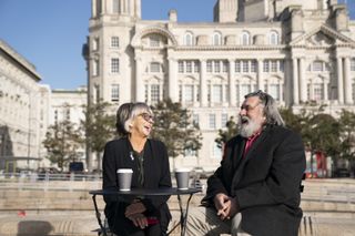 Sue Johnston and Ricky Tomlinson laughing while enjoying a coffee together on DNA Journey.