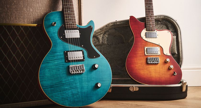 PJD Origin Series Carey Pro and PJD Origin Series St John Pro: the Sea Blue and Original Burst electric guitars are photographed against a fawn-coloured Vox amp with the offset resting on top of its case.