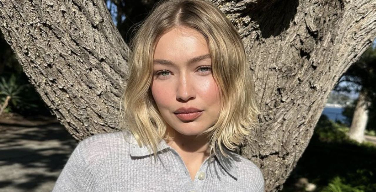 gigi hadid wears a gray henley shirt with a waffle knit