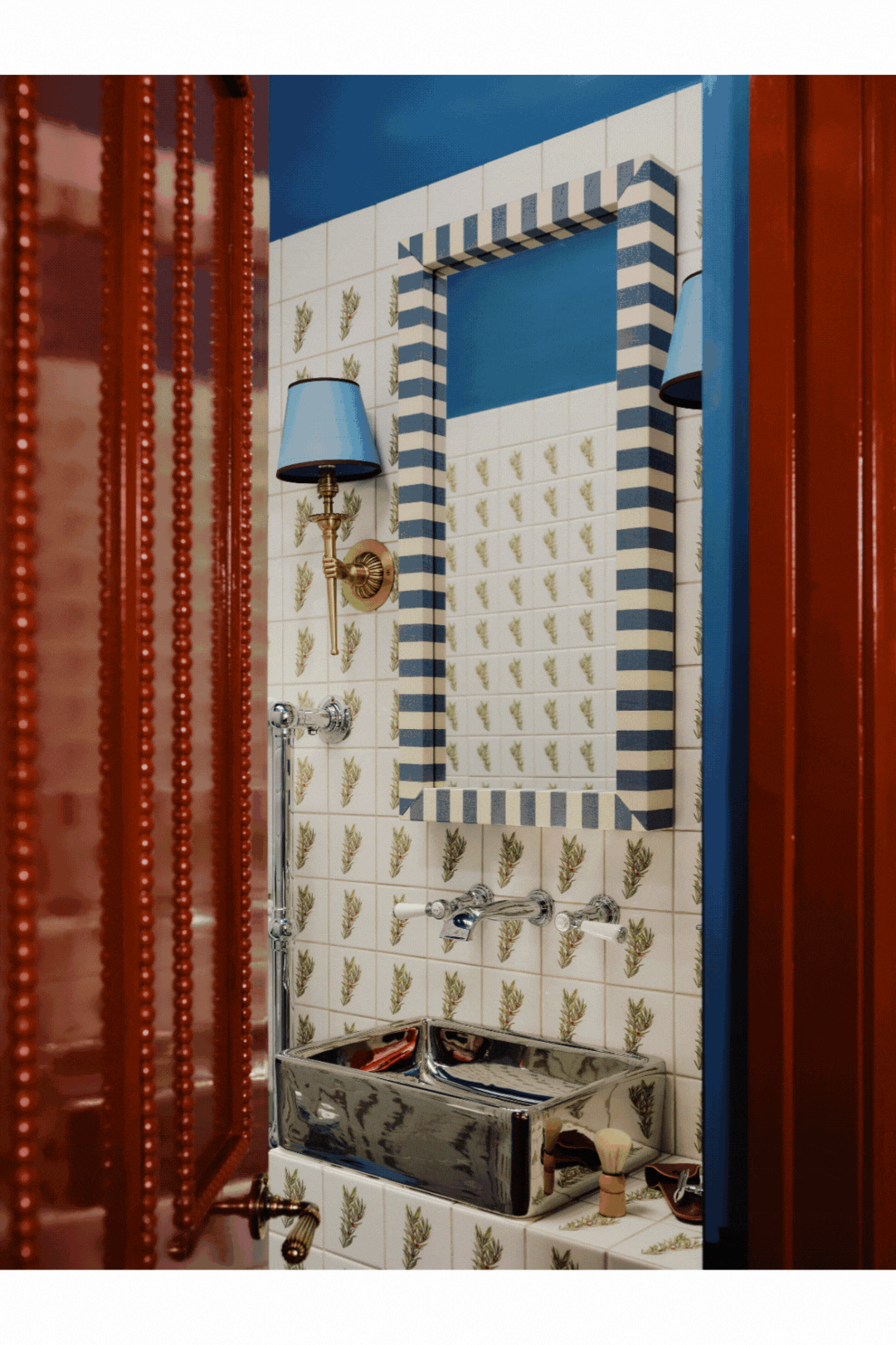 A rotating gif showcasing the maximalist interiors of a hotel with a blue, cream, red, pink, and mint green palette, patterned tiles, velvety fabrics, sheeny surfaces, and quirky textiles.