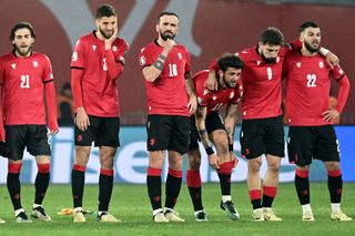 Georgia's players, including Nika Kvekveskiri (16), react during the penalty shoot-out during the UEFA EURO 2024 qualifying play-off final football match between Georgia and Greece in Tbilisi on March 26, 2024. (Photo by Vano SHLAMOV / AFP) (Photo by VANO SHLAMOV/AFP via Getty Images)