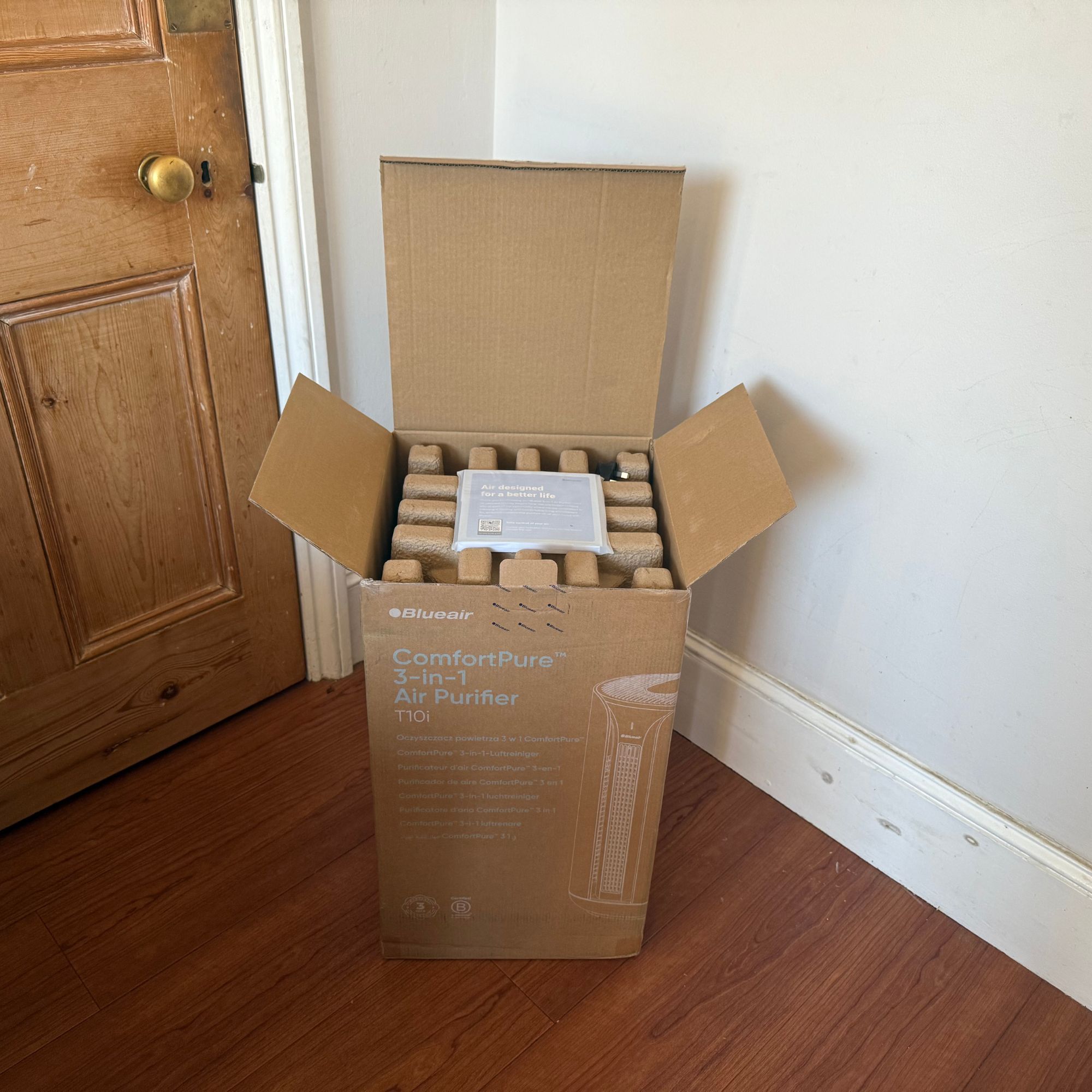 Blueair ComfortPure 3-in-1 T10i Air Purifier in its box with the lid open