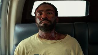 A bloodied John (Donald Glover) in a helicopter in Mr. & Mrs. Smith episode 4.