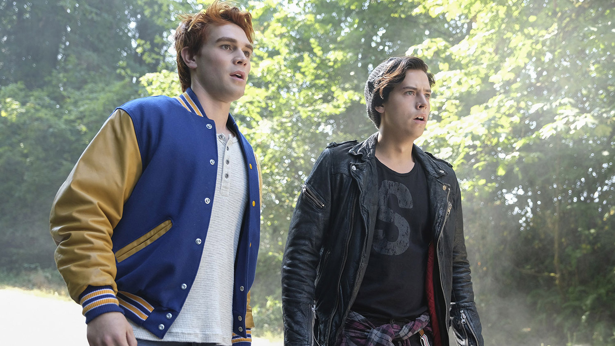 KJ Apa (as Archie) and Cole Sprouse (as Jughead) stare off camera, with mouths agape, in Riverdale