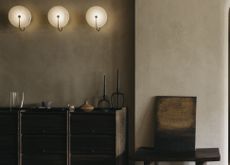 A corner in the living room with a console and chair, with walls finsihed in lime wash