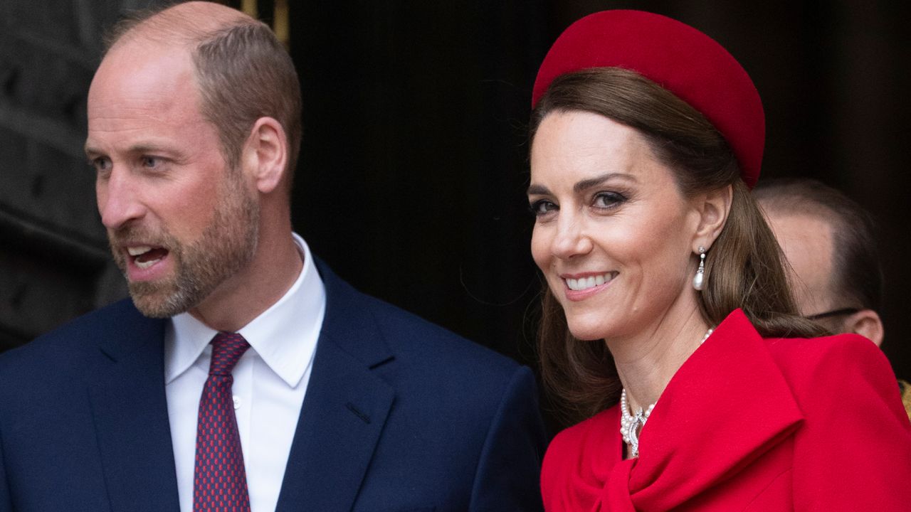 Kate Middleton wearing a red bow coat and hat smiling at the camera on Commonwealth Day 2025