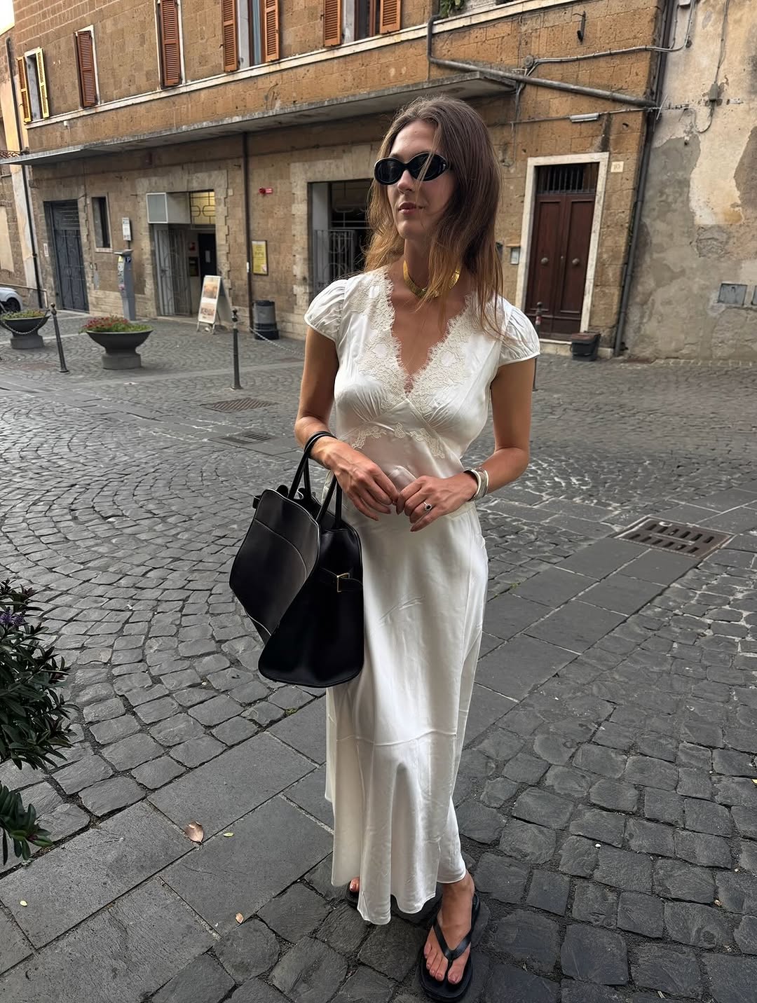 Olivia Wayman wears leather The Row City flip-flops