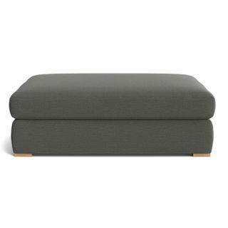 A dark gray upholstered ottoman from McGee & Co.