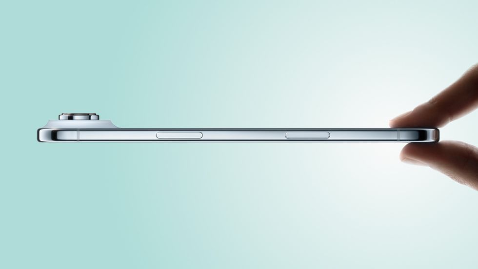 Apple iPhone Air shown from the side and being held from the bottom – against a blue background