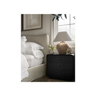 white bedsheets on bed with wood bedside table