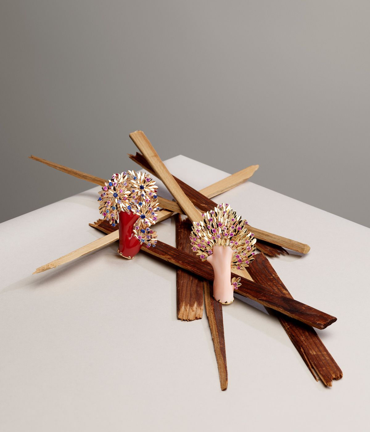 colourful Van Cleef &amp; Arpels Le Grand Tour collection brooches on wood