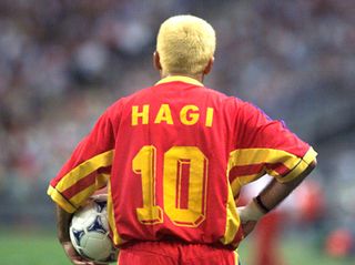 omania midfielder Gheorghe Hagi holds the ball on the pitch at the Stade de France in Saint-Denis 26 June during the 1998 Soccer World Cup group first round match between Romania and Tunisia. The teams drew 1-1.