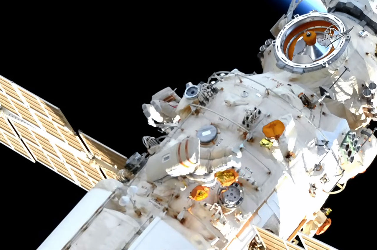 Russian cosmonauts Oleg Artemyev and Denis Matveev work outside of the Nauka multi-purpose laboratory module to begin configuring the new European Robotic Arm (ERA) for use during a spacewalk at the International Space Station on Monday, April 18, 2022.