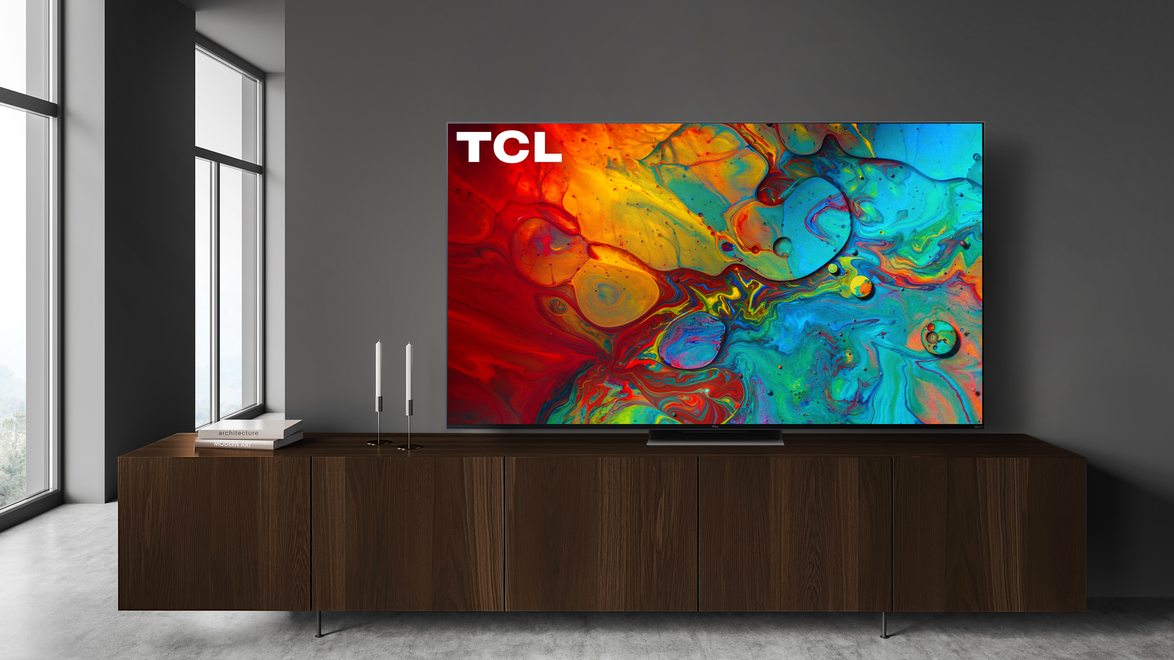 The 2022 TCL R655 hanging on a wall in a living room.