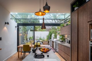 a modern home with a large rooflight with a connection to the outdoor space