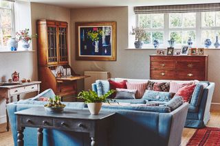 living room with blue sofas antique furniture in converted Victorian school